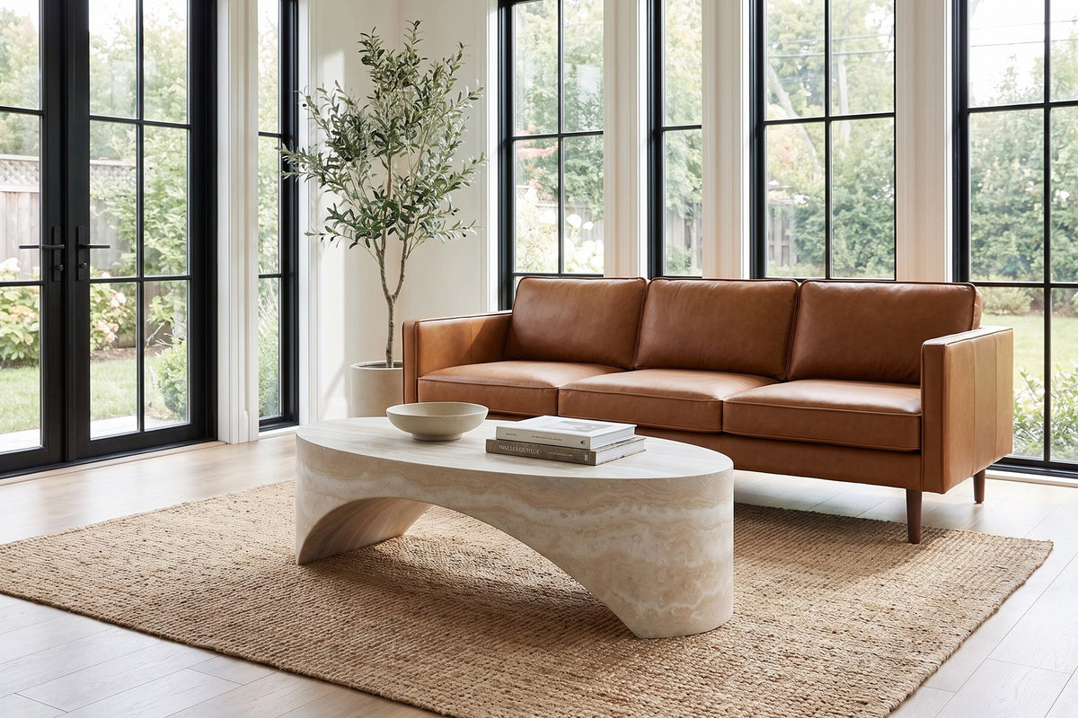 Daylight. On a jute rug in a sunroom, the long arch keeps the table light.
