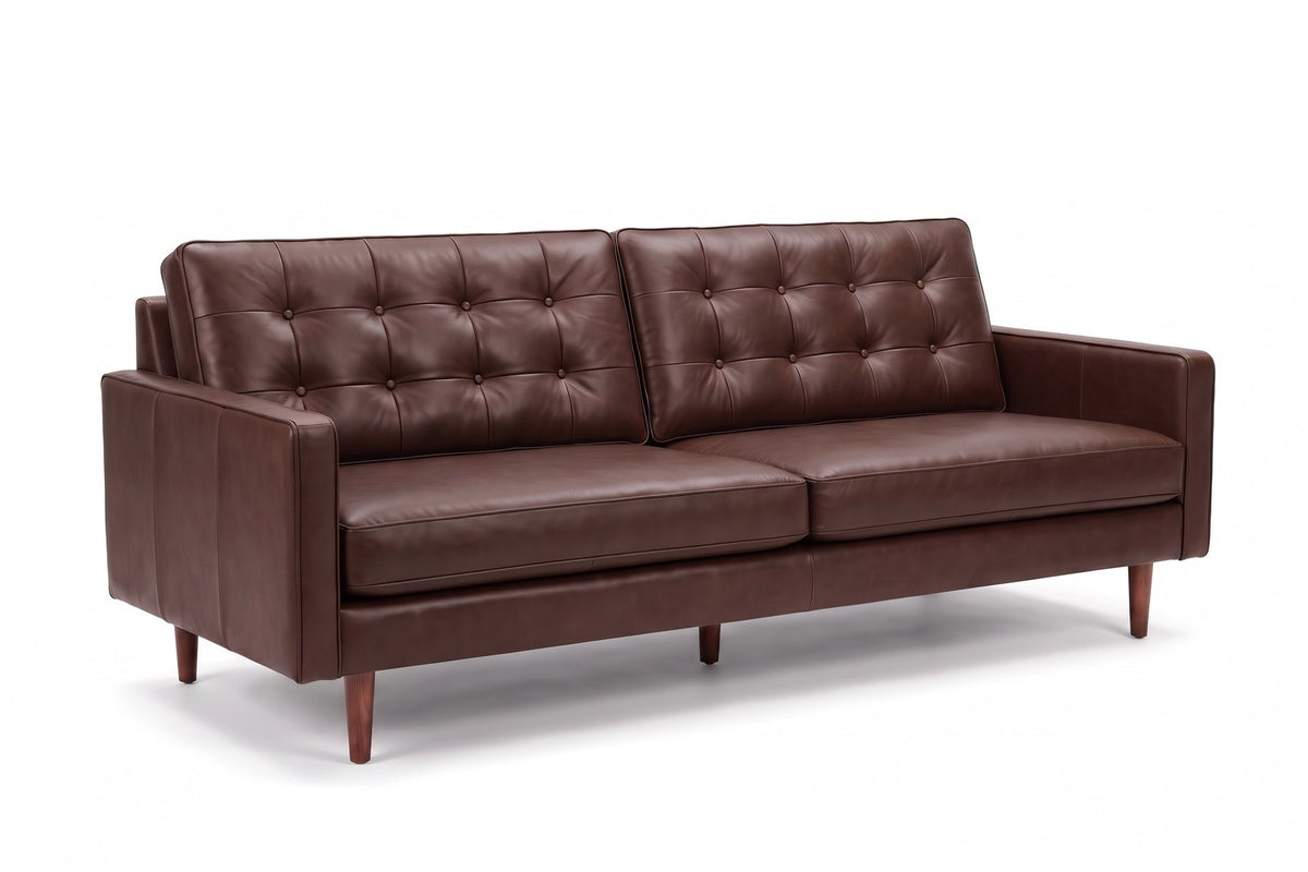Amboise Button-Tufted Leather Sofa in Chocolate, three-quarter view on white
