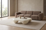 Amélie square sculpted coffee table in matte cream white in a calm, daylit living room