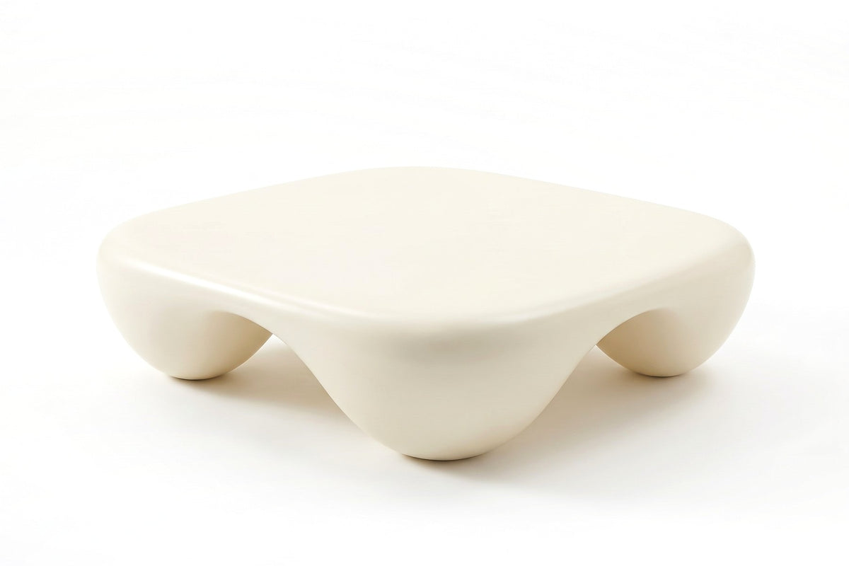 Amélie square sculpted coffee table in matte cream white, three-quarter view from slightly above, showing the flat top and two sides with their arches on a white background