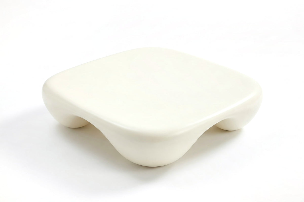 Amélie square sculpted coffee table in matte cream white, view from high above, showing the full soft-cornered square top on a white background