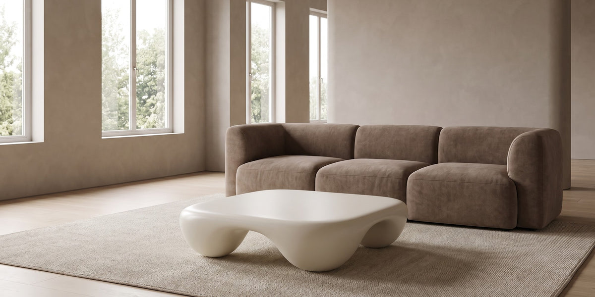 Amélie square sculpted coffee table in matte cream white in a wide, calm living room