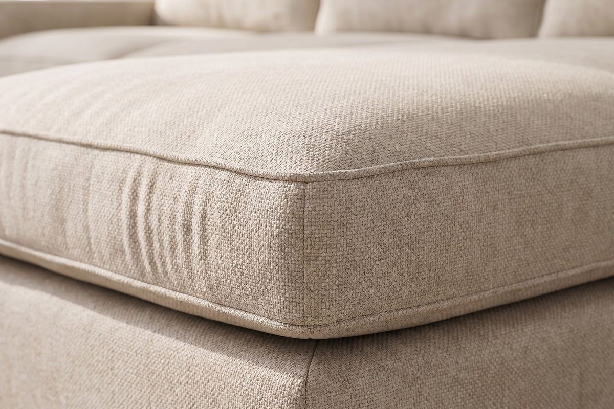 Annecy Modular L-Shaped Sectional: close-up of a seat cushion corner, showing the oatmeal chenille texture and the neat self-welted edge