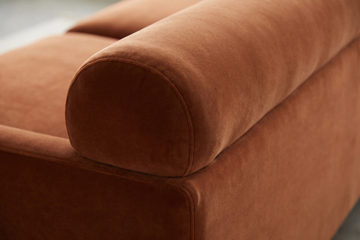 Antibes Cognac Velvet Sofa: close-up of the thick rounded top roll of the back and the soft sheen of the cognac velvet