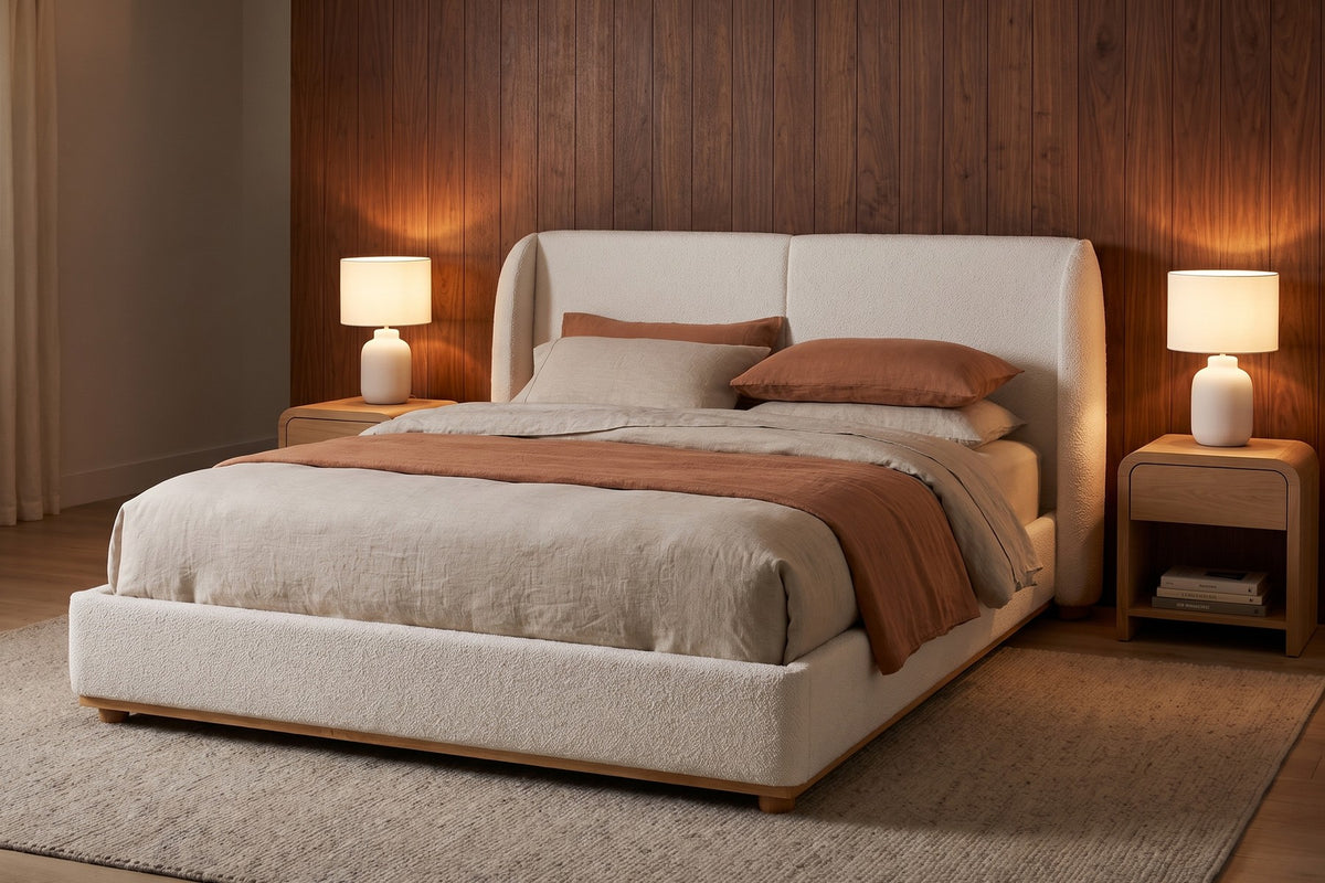 Evening. Rounded wings frame the pillows, with a lamp glowing on each side.
