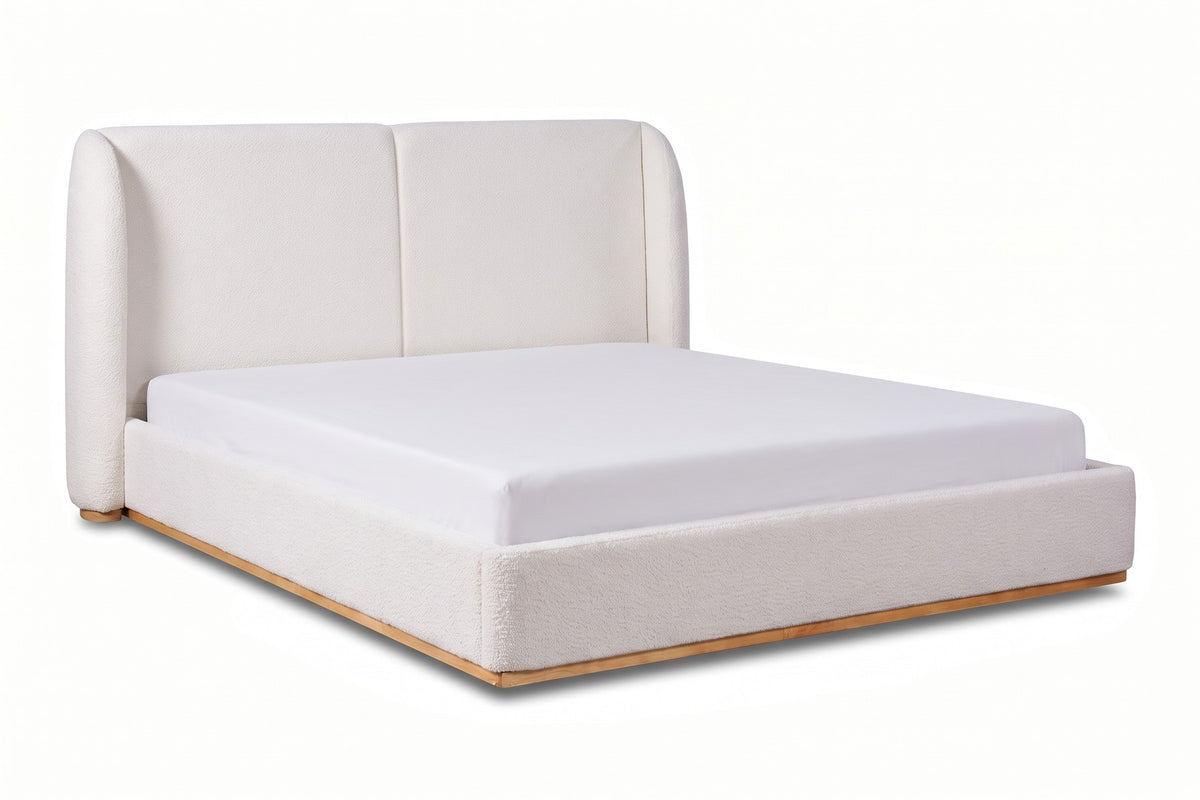 Apolline white bouclé platform bed with a wingback headboard, three-quarter view from the foot of the bed, slightly above on a white background