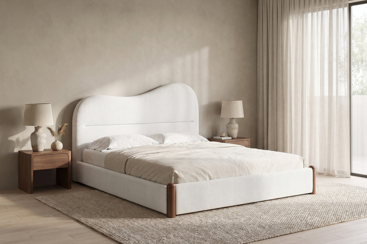 Aurore white Berber fleece king bed with a wavy headboard and walnut-finish feet in a calm, daylit bedroom