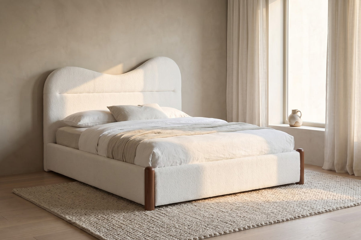 By a sheer-curtained window, the low rails and rounded walnut feet stay quiet.