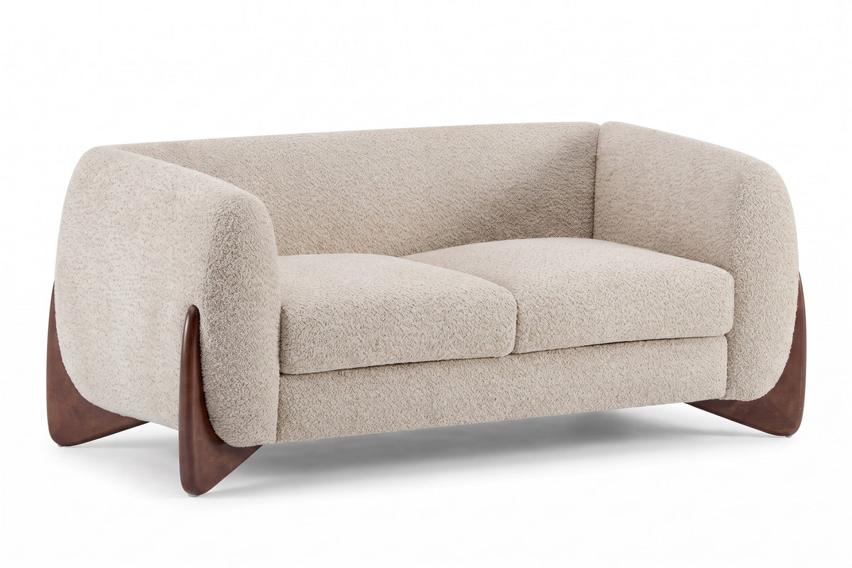 Auteuil almond bouclé loveseat with sculpted walnut-finish feet, three-quarter front view on a white background