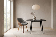 Bastien bentwood dining chair at the round black Marais table in a calm daylit dining room