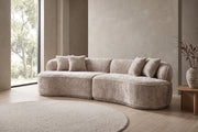 Bastille camel bouclé curved two-piece sectional in a calm, daylit living room