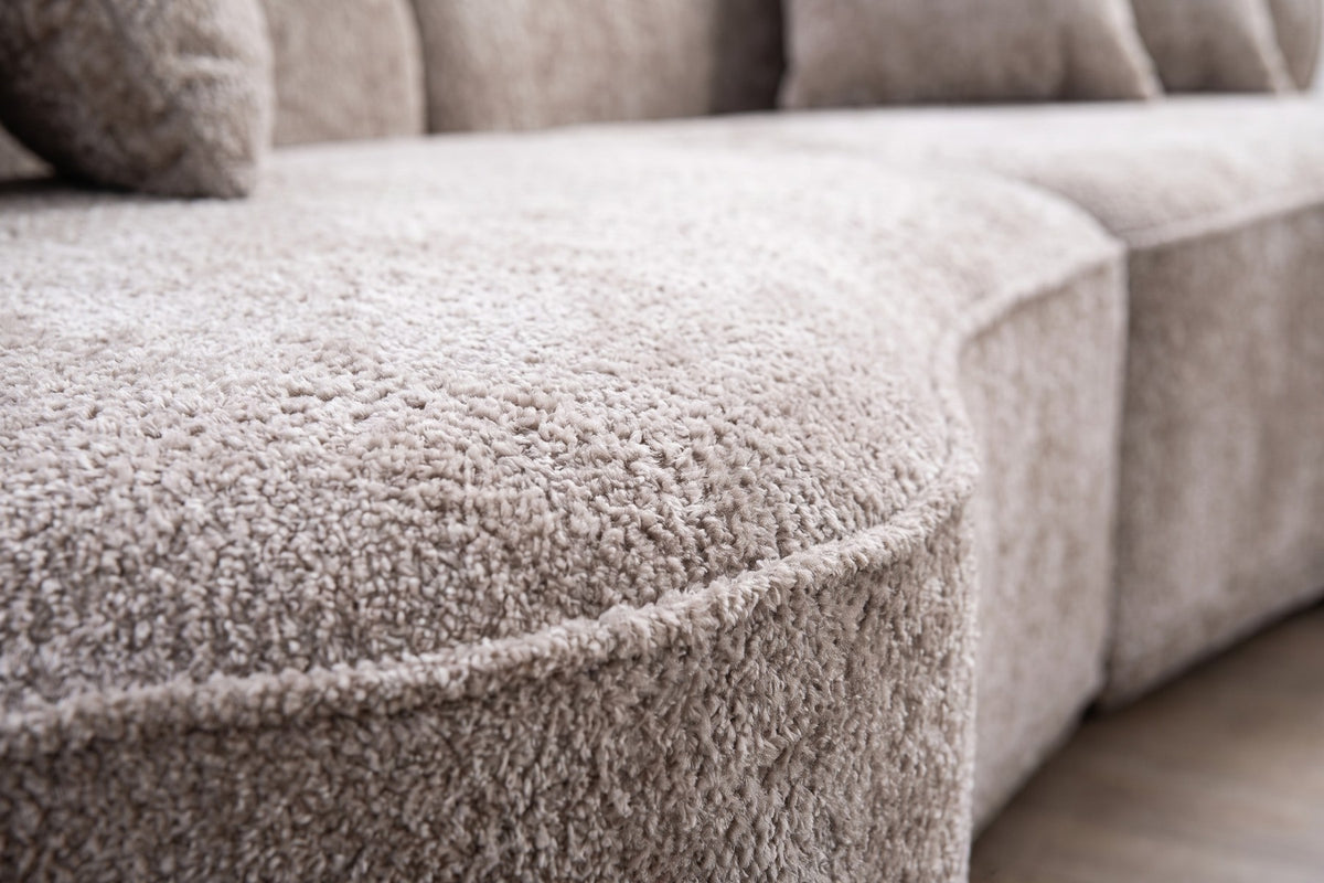 Close-up of the soft shaggy camel boucle on the curved seat edge (Bastille)