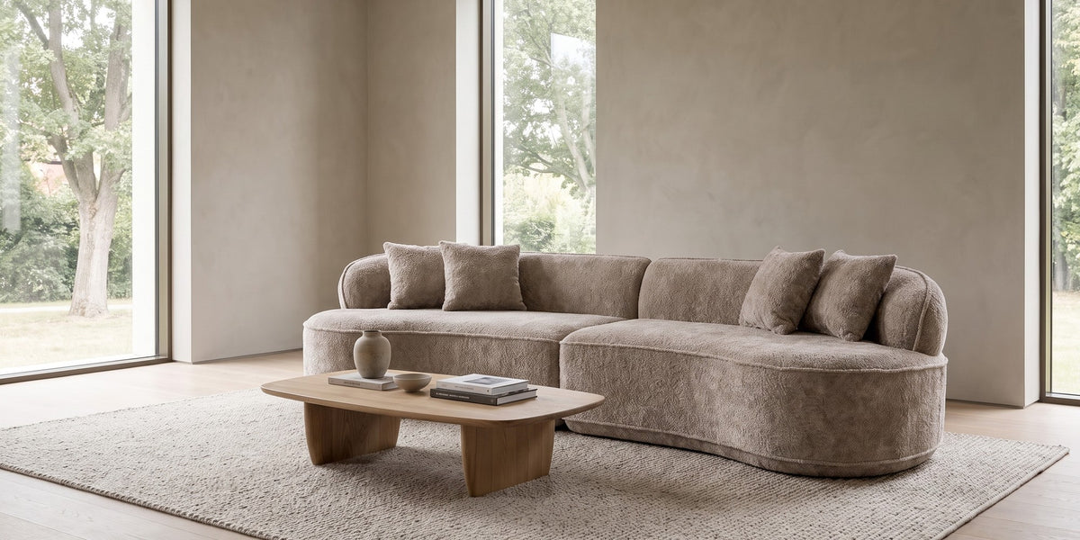 Bastille camel bouclé curved two-piece sectional in a wide, calm living room