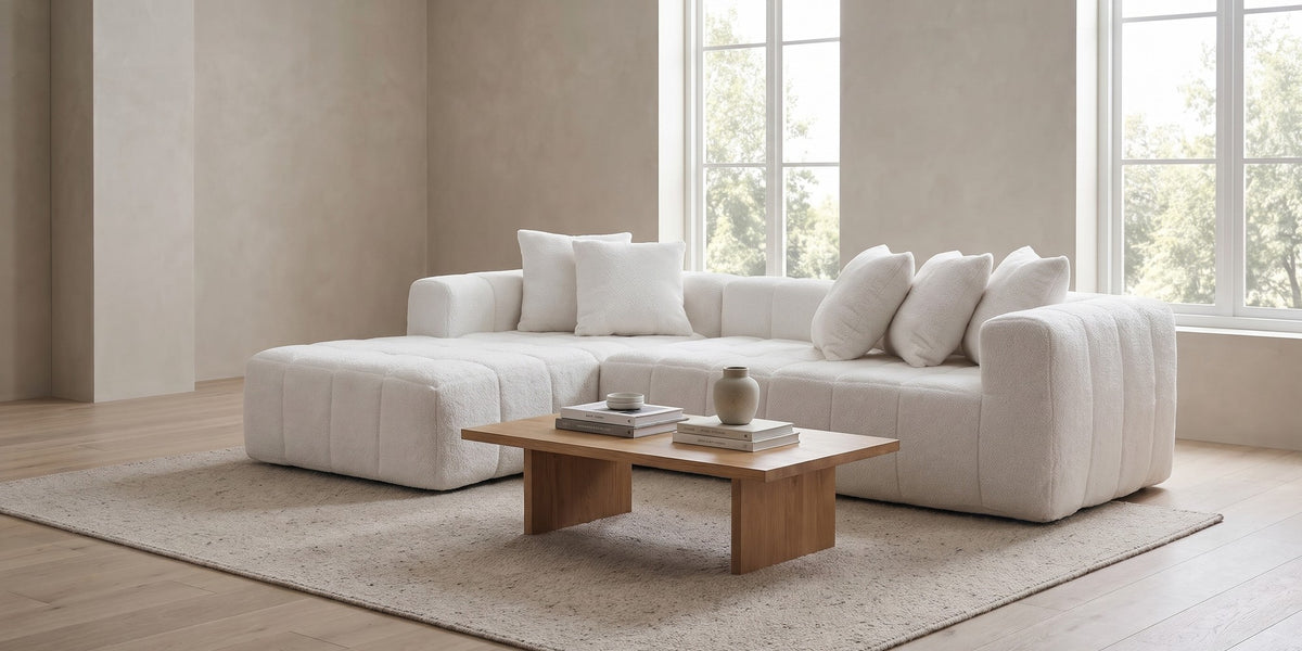 Batignolles white bouclé grid-tufted l-shaped sectional with left-facing chaise in a wide room view