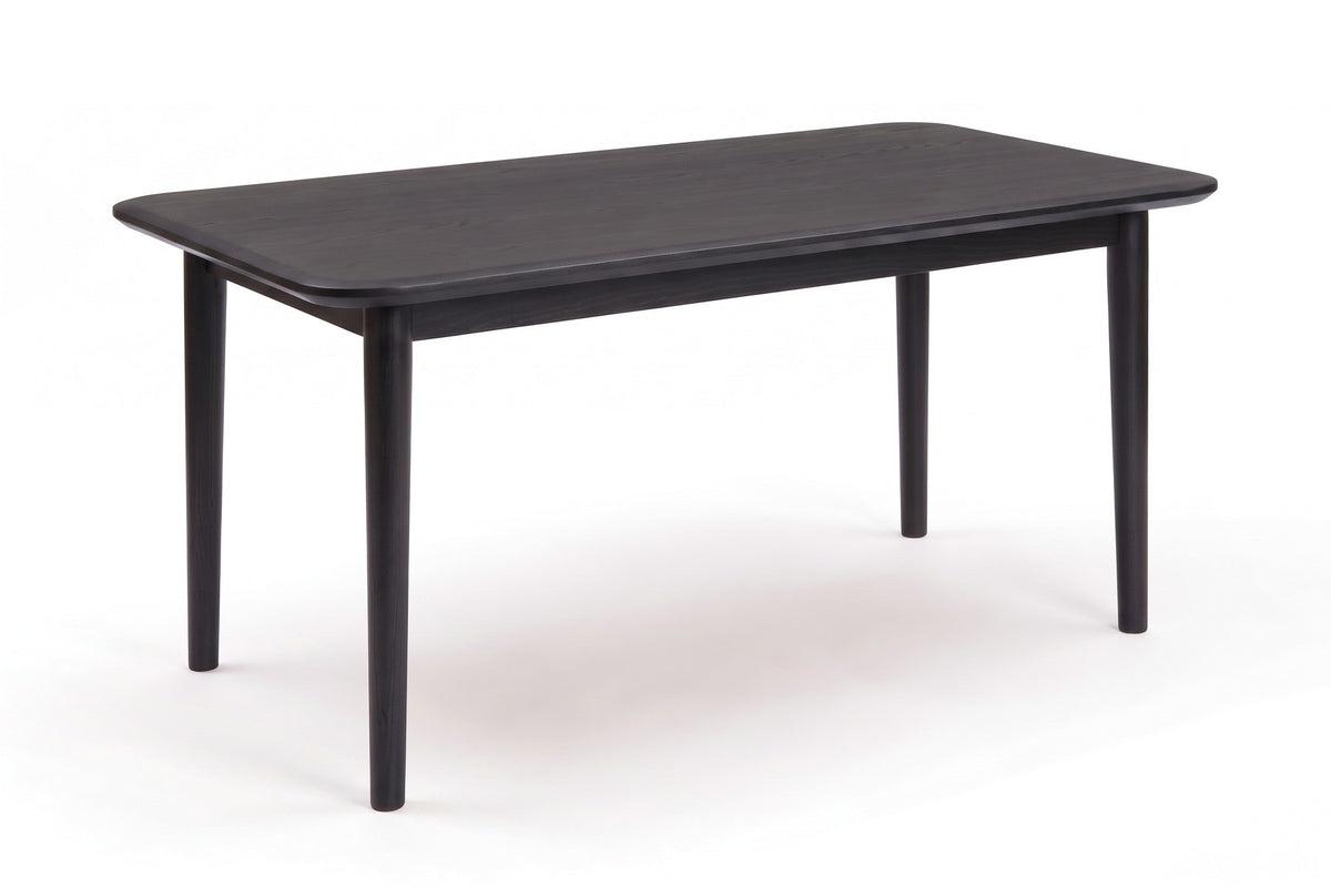 Beaune Dining Table in Black Oak, three-quarter view on white