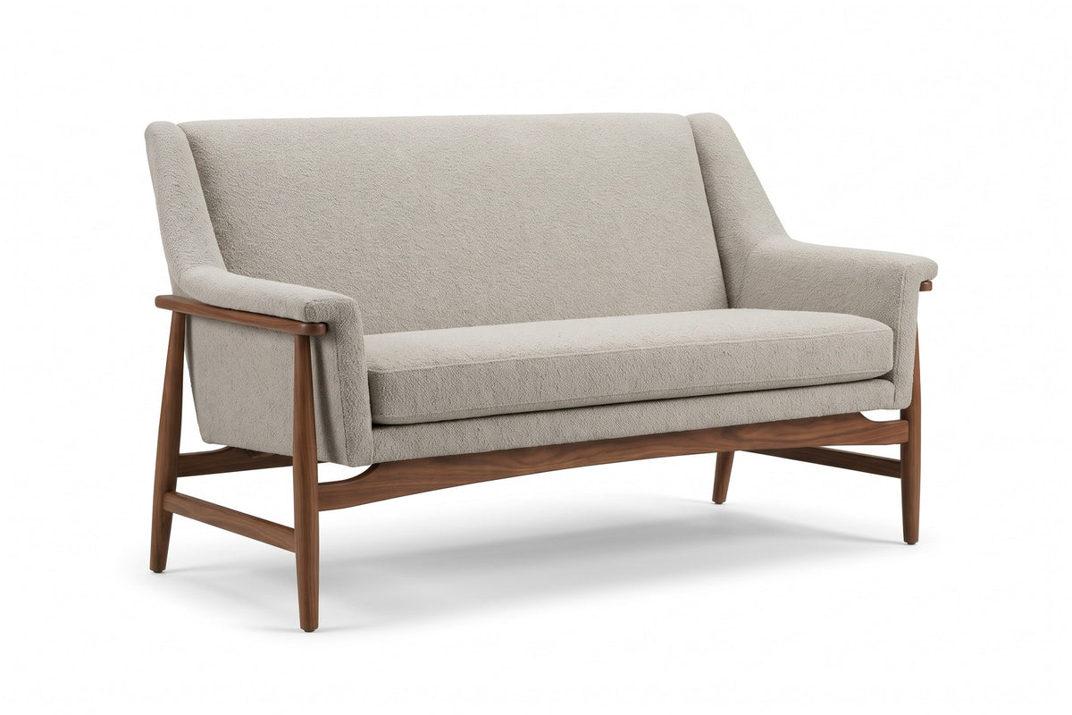 Bercy almond bouclé loveseat with flared arms and a walnut-finish frame, three-quarter front view on a white background