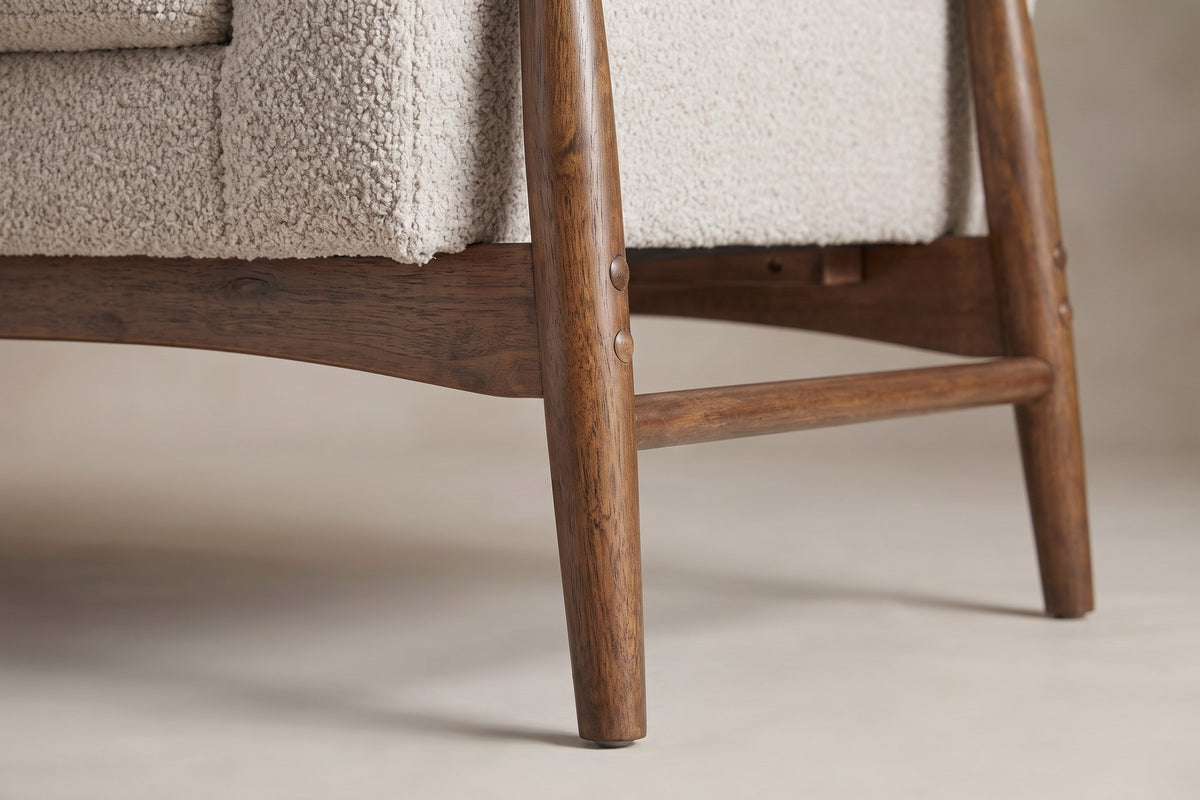 Close-up of a splayed walnut-finish leg and side stretcher (Bercy)