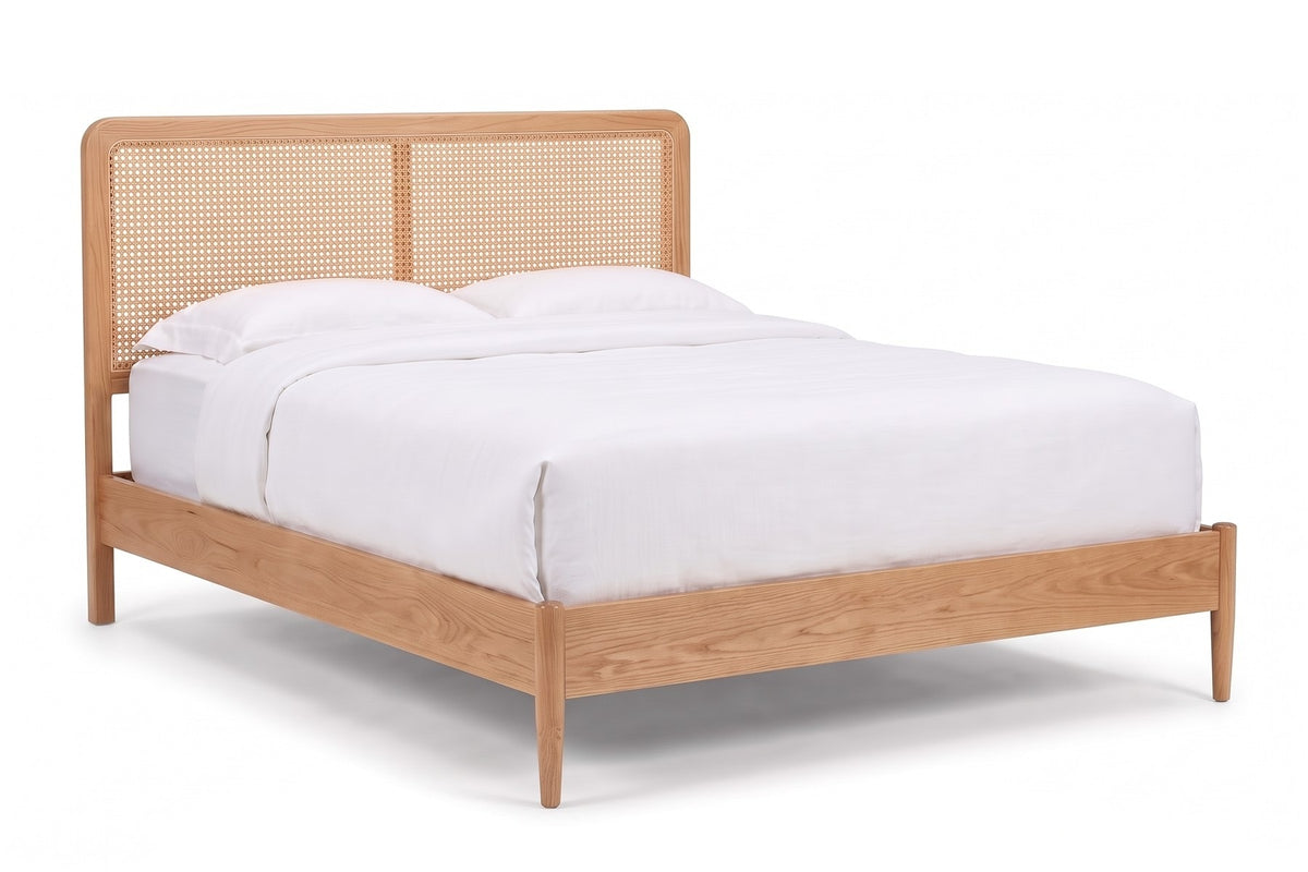 Bergerac Cane Bed in Natural Oak, three-quarter view on white