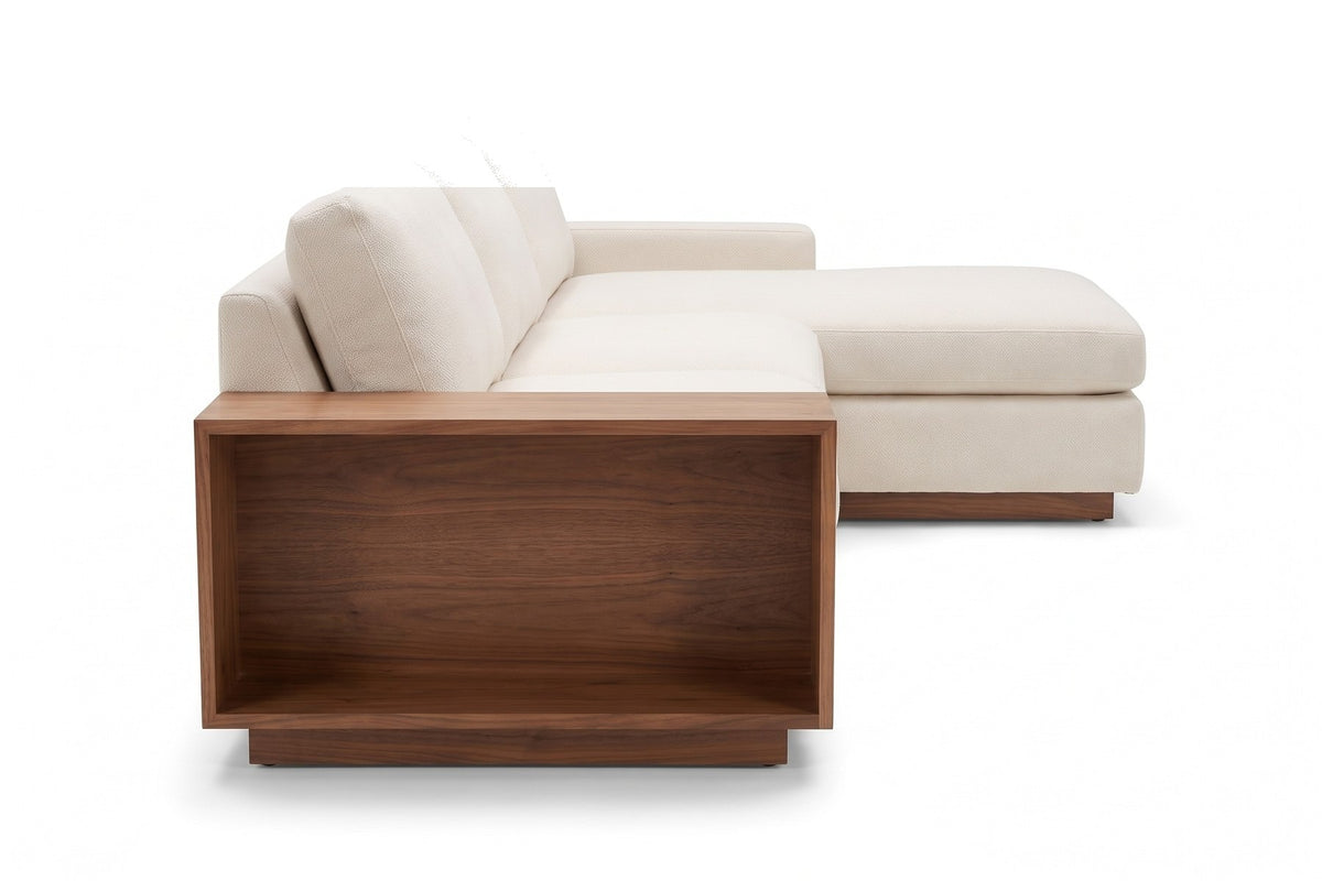 Biarritz Ivory Low Chaise Sectional with Walnut Side Table, straight side view from the left at seat height, showing the walnut side table end and its open shelf