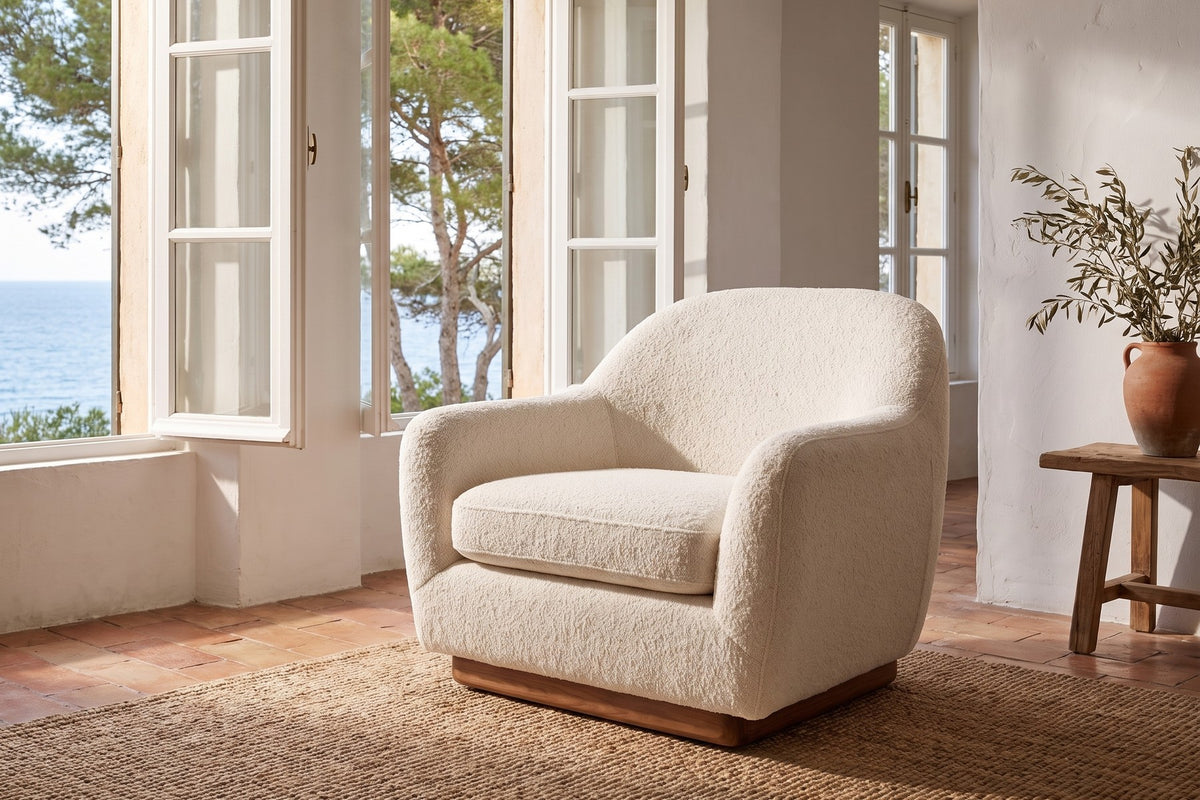 Biot Ivory Bouclé Lounge Chair in a villa with a sea view, seen from the front right