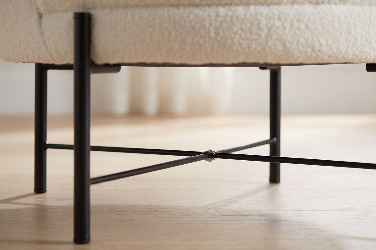 Close-up of the slim black metal legs and cross brace