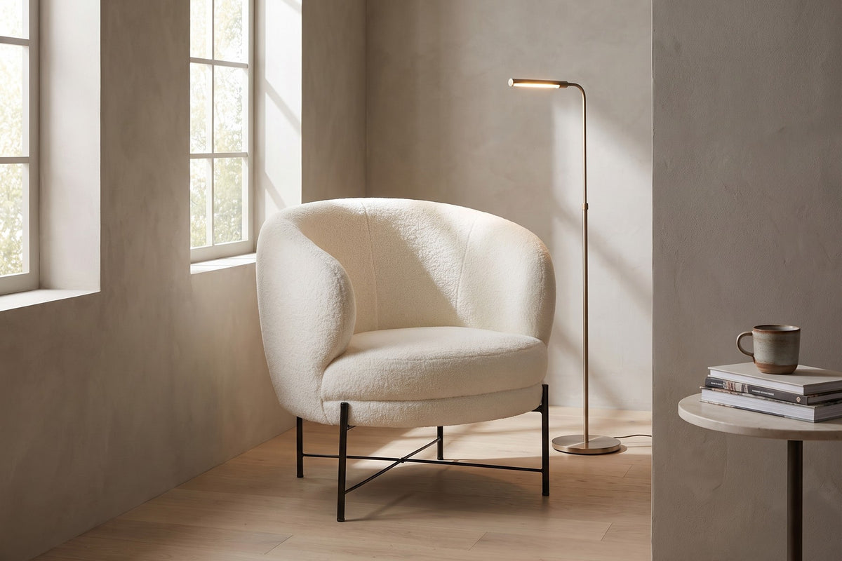 A reading corner. A lamp behind, books at hand and a back that wraps around you.