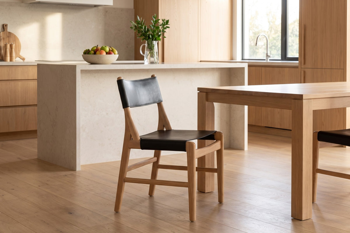 Cassis Leather Sling Dining Chair in Black / Natural Oak, in a room setting