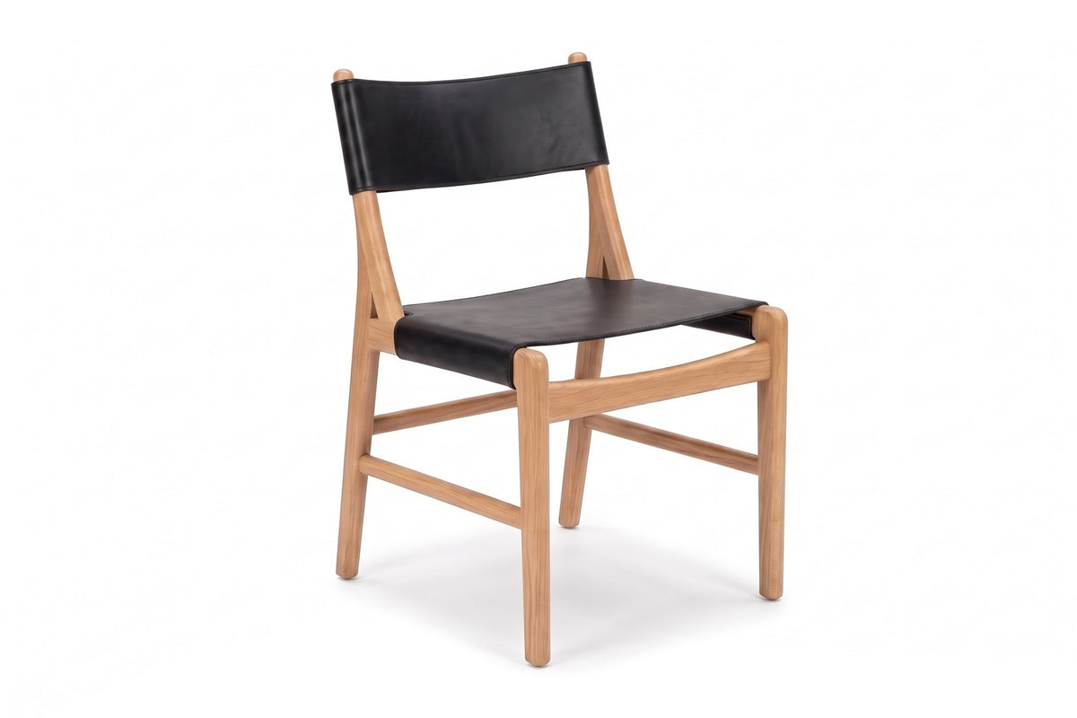 Cassis Leather Sling Dining Chair in Black / Natural Oak, three-quarter view on white