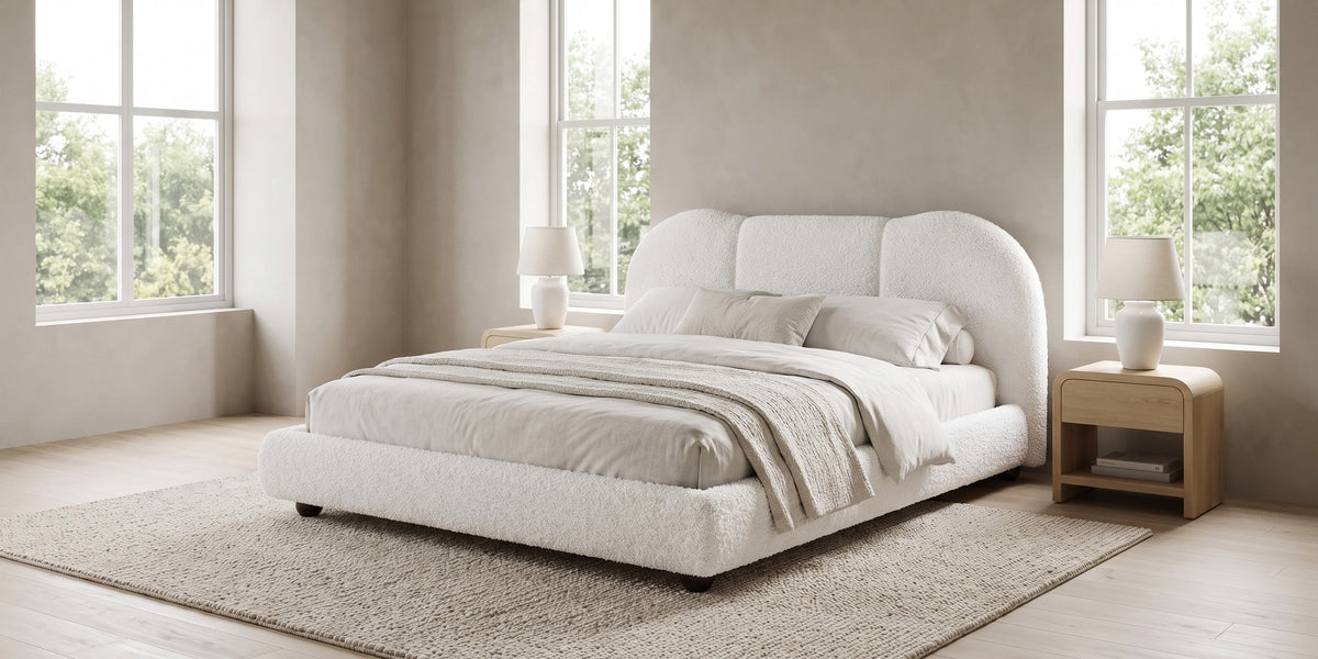 Celeste white bouclé platform bed with a cloud headboard in a wide, calm bedroom