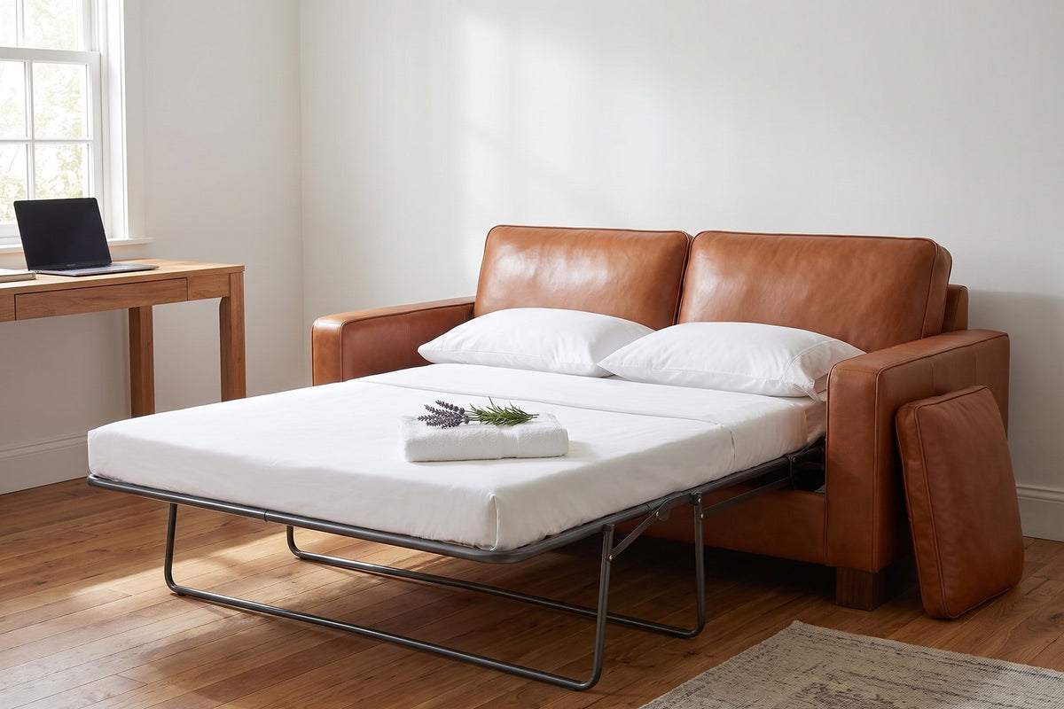 Chamonix Cognac Leather Sleeper Sofa with the bed opened and made up in a home office guest room