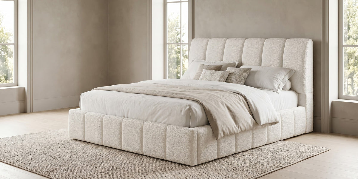 Clémence white boucle channel-tufted king platform bed in a wide room view