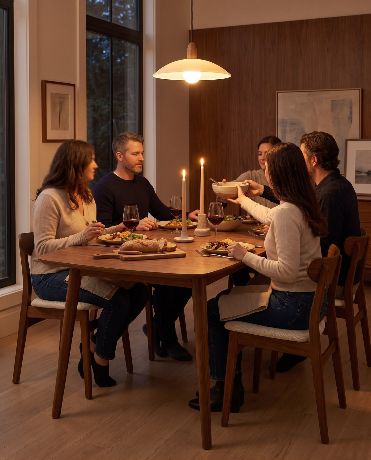 Four people sharing dinner around the Cluny walnut dining table (concept image)