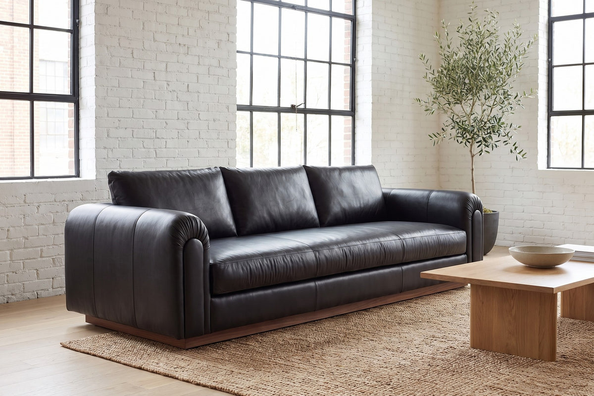 Collioure 88" Low Leather Sofa – Gathered Arms, Bench Seat, Walnut Plinth