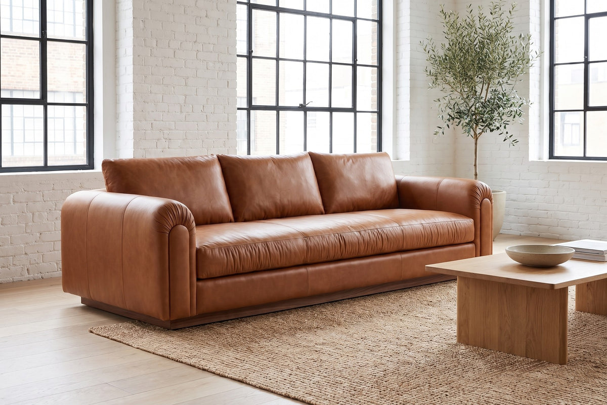 Collioure 88" Low Leather Sofa – Gathered Arms, Bench Seat, Walnut Plinth