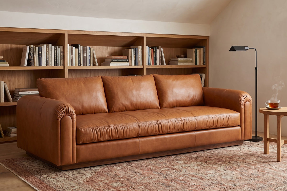 Collioure 88" Low Leather Sofa – Gathered Arms, Bench Seat, Walnut Plinth