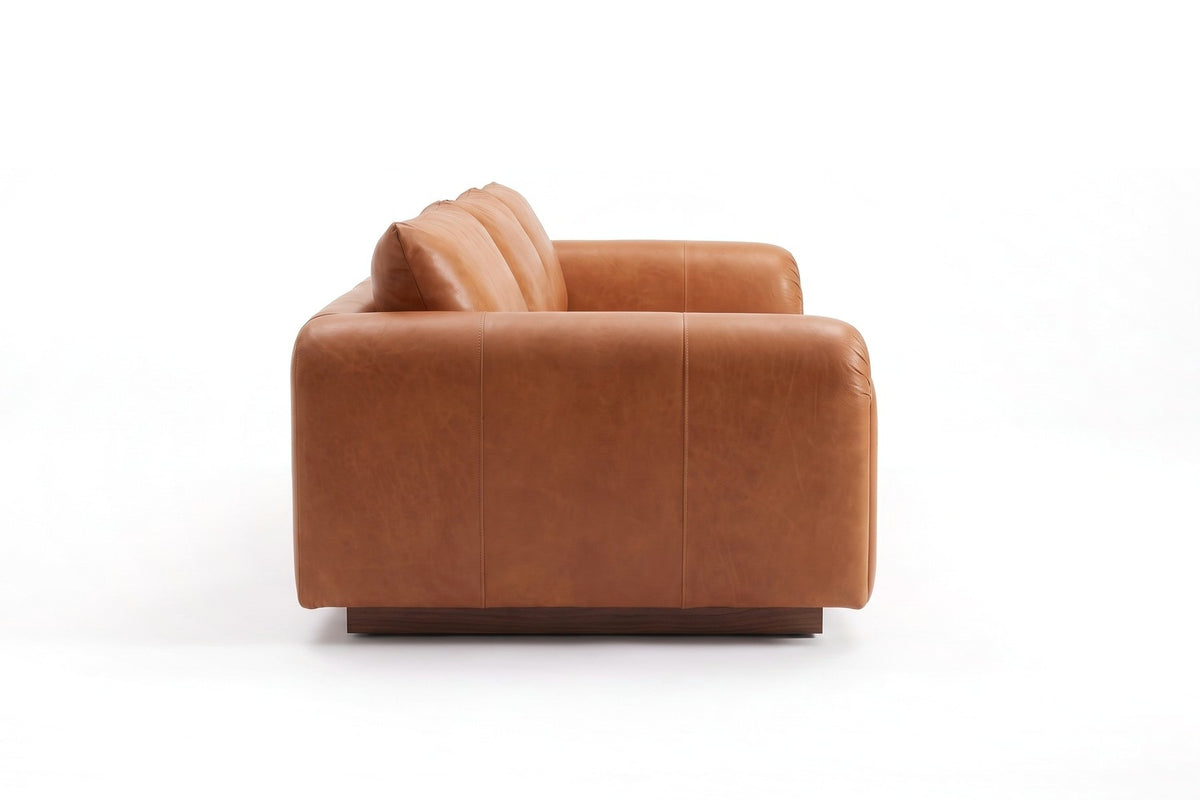 Collioure 88" Low Leather Sofa – Gathered Arms, Bench Seat, Walnut Plinth