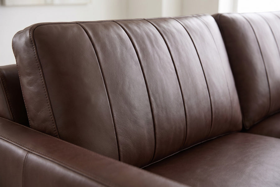 Colmar 86" Chocolate Leather Sofa: close-up of one chocolate leather back cushion, showing the vertical stitched channels, the leather grain and its soft sheen