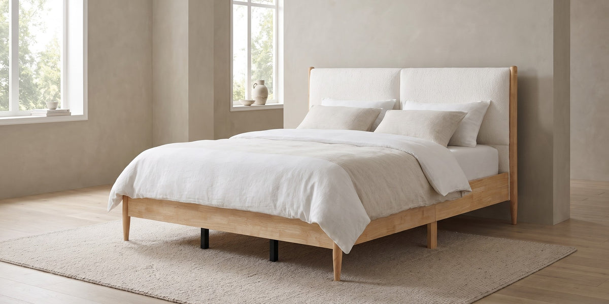 Delphine california king natural wood bed with white upholstered headboard in a wide room view