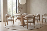 Elise beige upholstered dining chair with a light ash rubberwood frame in a calm, daylit dining room