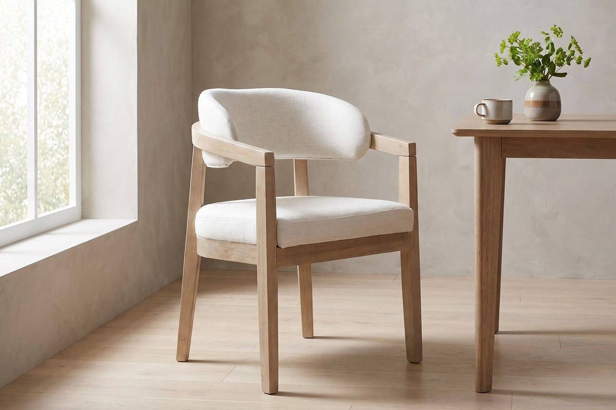 Elise beige upholstered dining chair with a light ash rubberwood frame in a bright breakfast nook