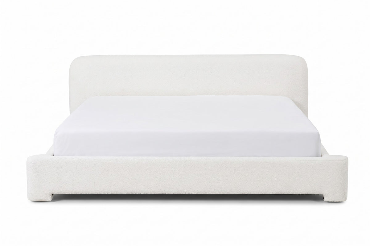 Elodie low white bouclé platform bed with rounded rails, straight front view from the foot of the bed, at mattress height on a white background