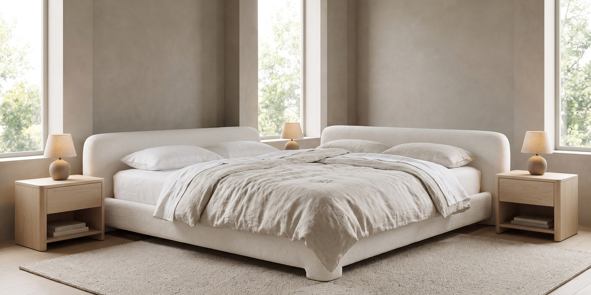Elodie low white bouclé platform bed with rounded rails in a wide, calm bedroom