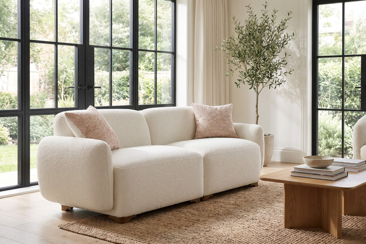 Daylight. By tall garden windows, the low, rounded form keeps the room open.