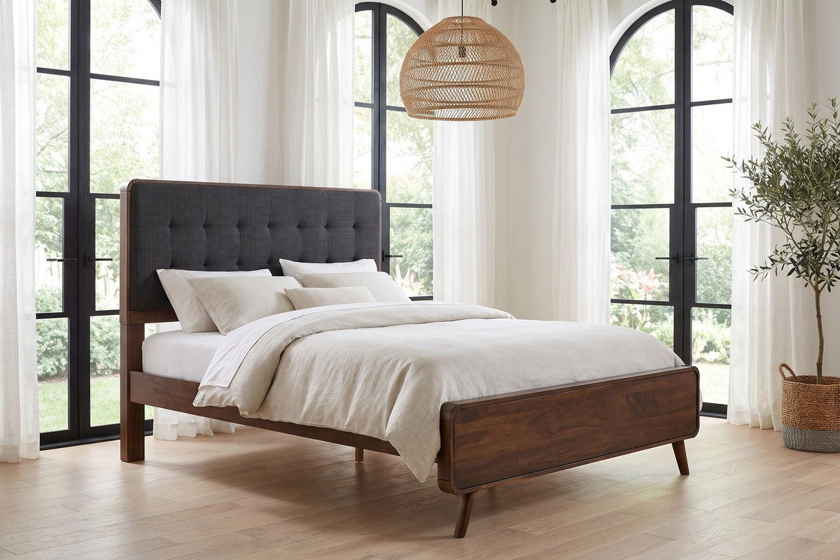Daylight. Under tall arched windows, the splayed legs keep the bed light on its feet.