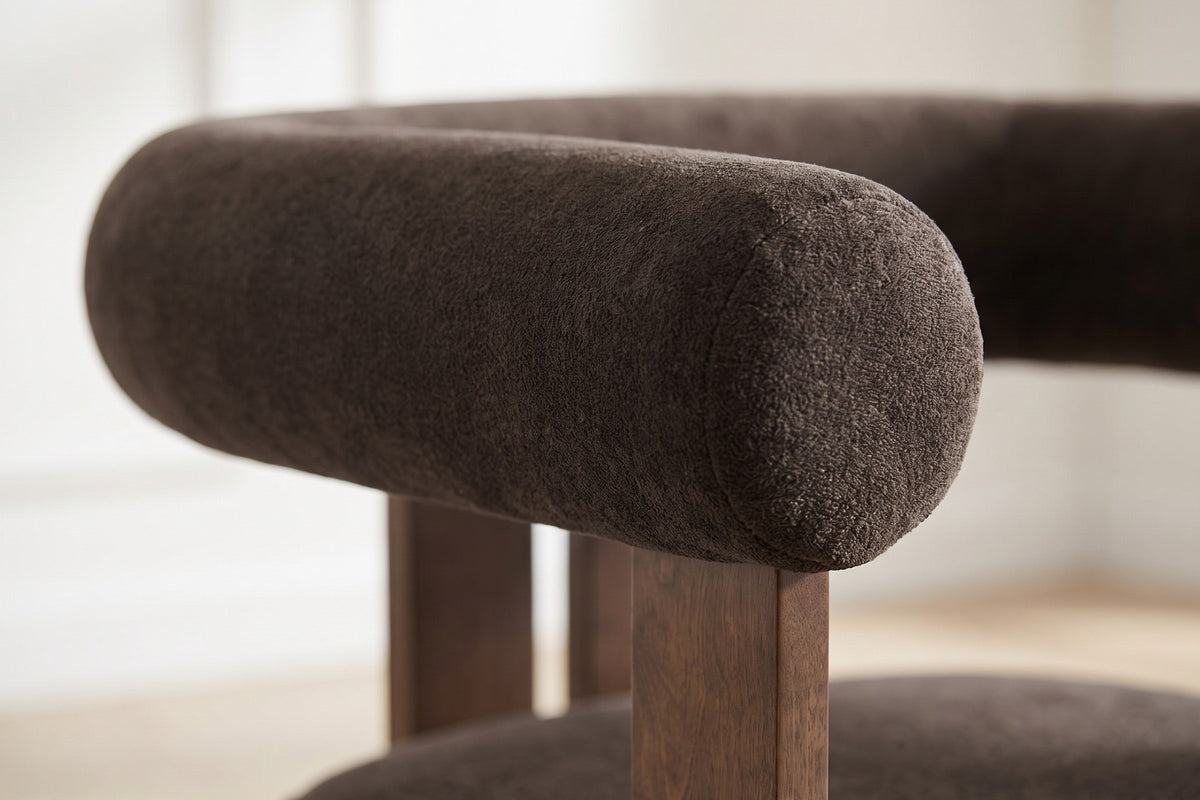 Close-up of the round dark brown velvet arm bolster (Gaspard)
