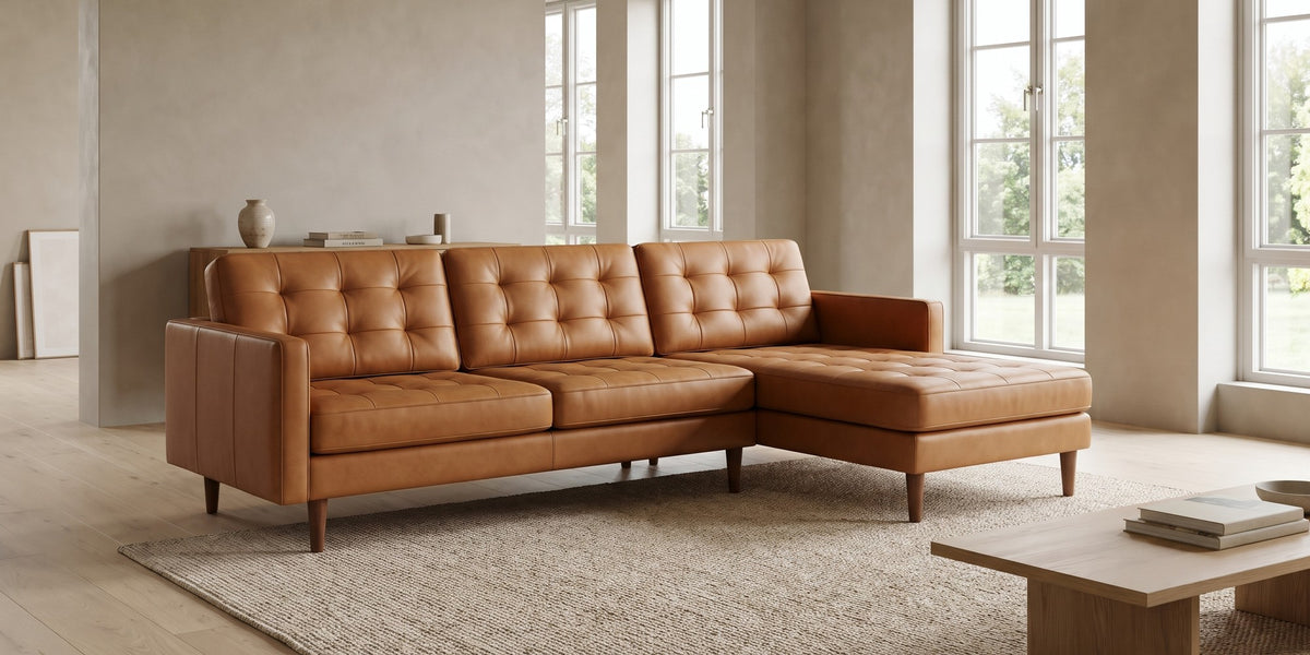Grenelle tan top-grain leather sectional with right-facing chaise and button-tufted back in a wide room view