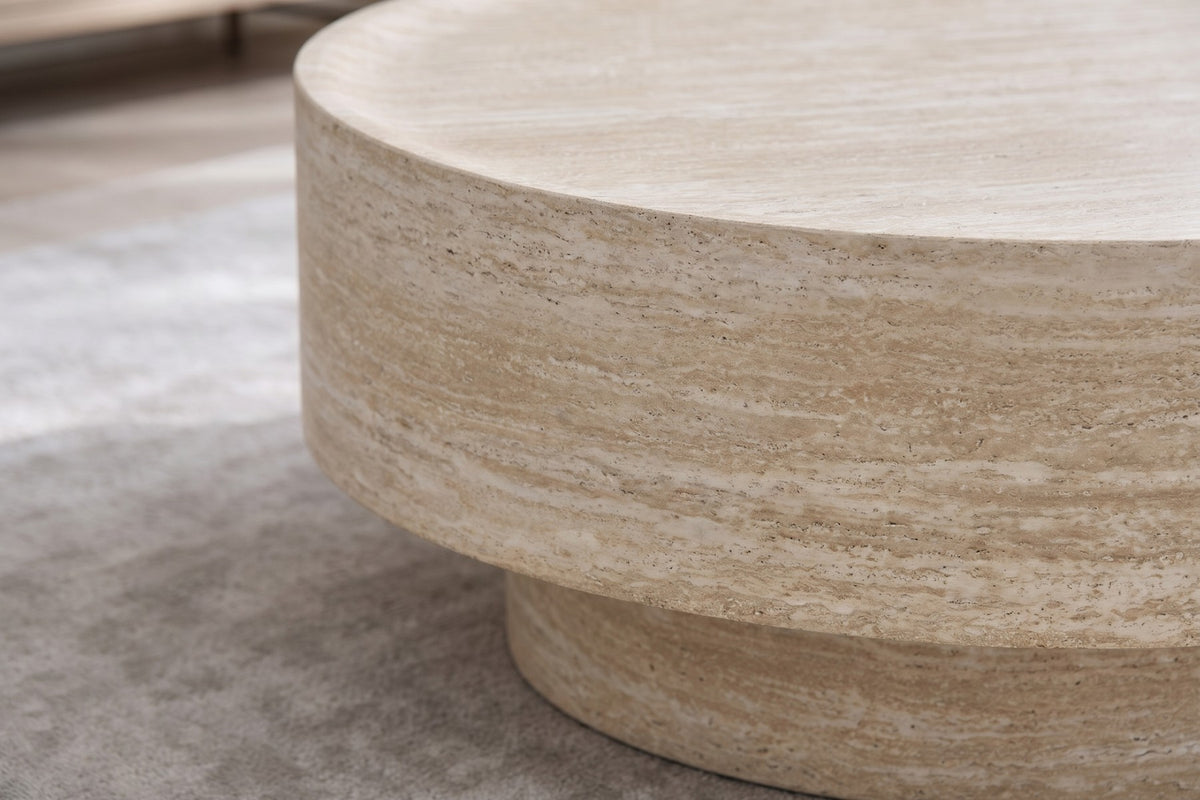 Close-up of the edge of the top and the recessed base below it, showing the raised rim, the shadow gap and the sand-beige travertine-look veining wrapping the side (Haussmann)