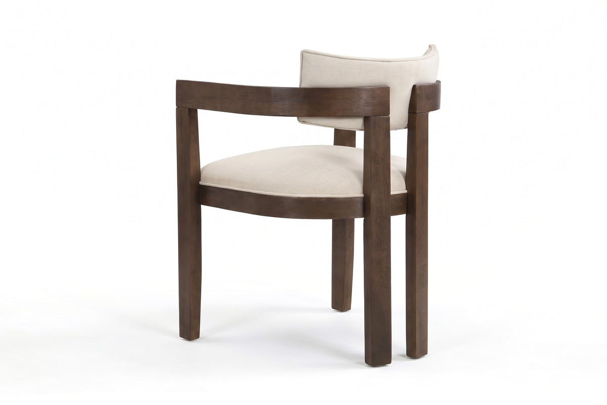 Henri beige dining armchair with a walnut-finish rubberwood frame, three-quarter back view, showing the two close-set back legs and the curved arms meeting at the centre, on a white background