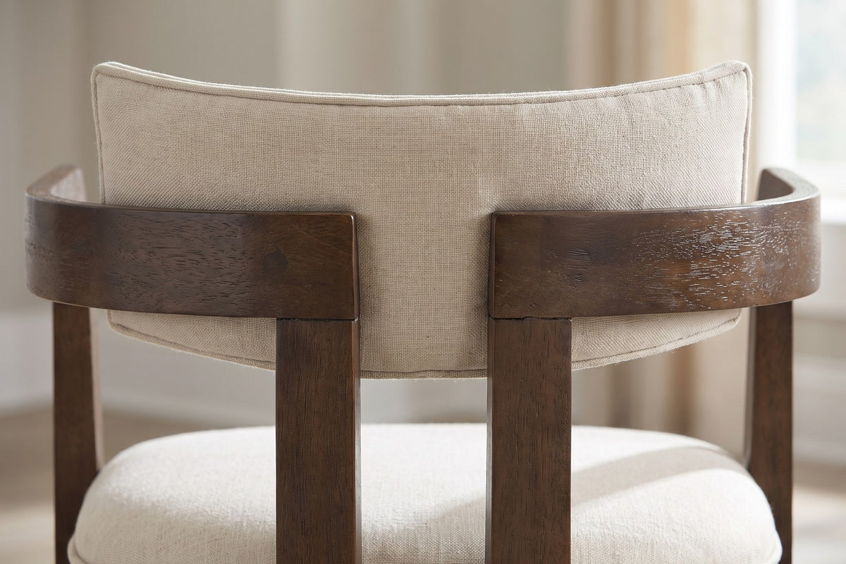 Close-up of the padded beige backrest with its piped edge above the curved walnut-finish arm rails (Henri)