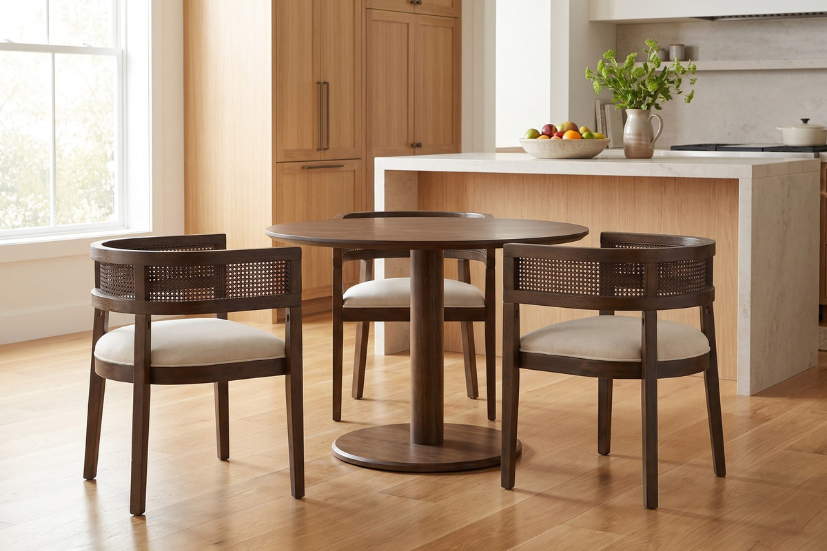 Ines cane barrel dining chair with a walnut-finish frame and beige seat in a bright open-plan kitchen and dining space